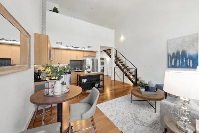 living room featuring sink and light hardwood / wood-style flooring