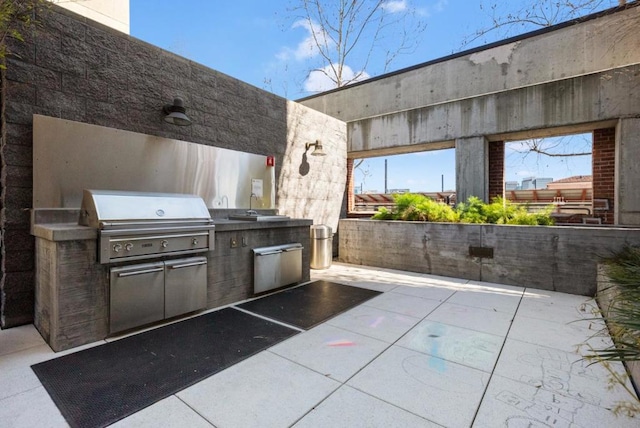 view of patio with area for grilling and exterior kitchen