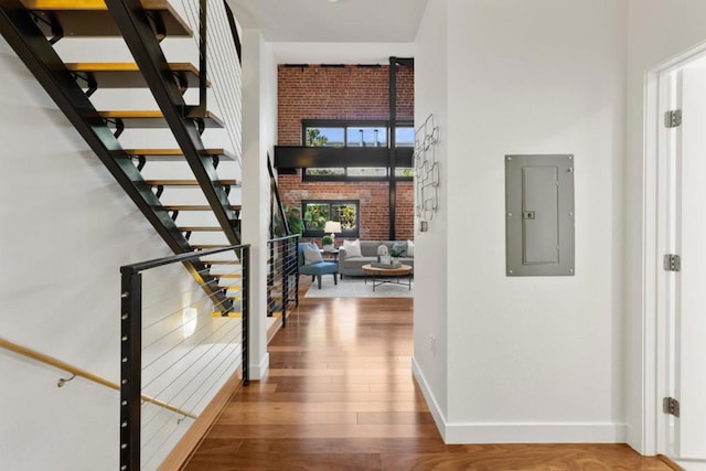 corridor featuring hardwood / wood-style floors and electric panel