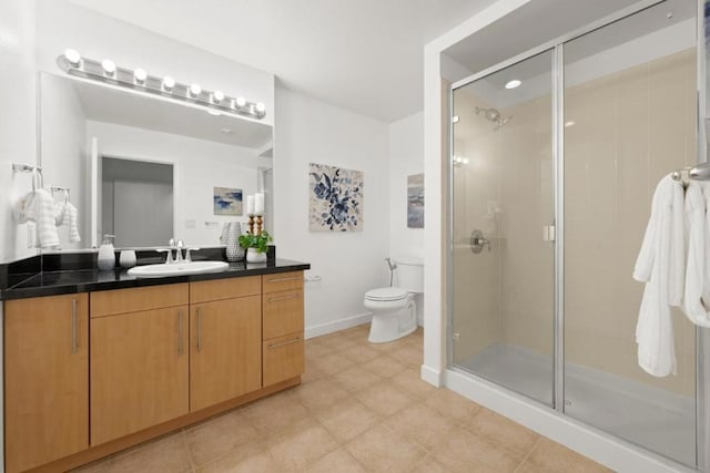 bathroom featuring vanity, toilet, and an enclosed shower