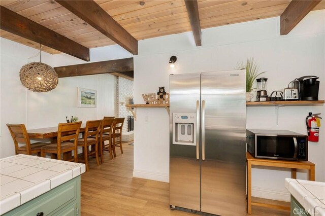 kitchen featuring wood ceiling, appliances with stainless steel finishes, tile countertops, light hardwood / wood-style floors, and green cabinetry