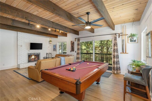 recreation room with beamed ceiling, light hardwood / wood-style flooring, track lighting, and wooden ceiling