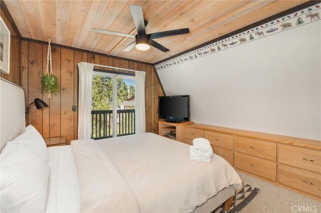 bedroom featuring wood walls, wood ceiling, access to exterior, and ceiling fan