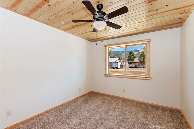 empty room with ceiling fan, wooden ceiling, and carpet floors