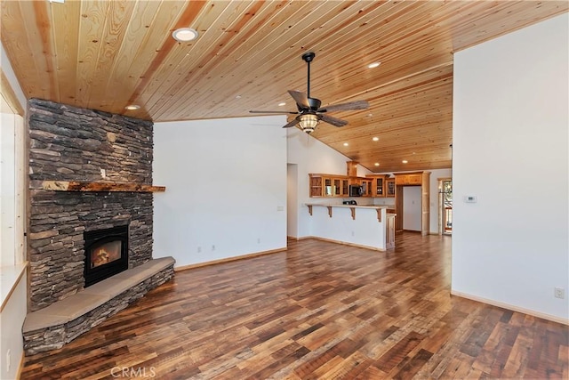 unfurnished living room featuring wooden ceiling, high vaulted ceiling, dark hardwood / wood-style floors, ceiling fan, and a fireplace