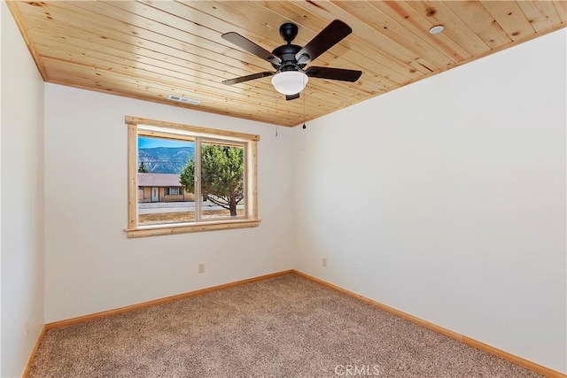 empty room with carpet floors, ceiling fan, and wood ceiling