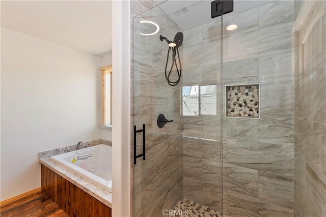 bathroom featuring separate shower and tub and hardwood / wood-style floors