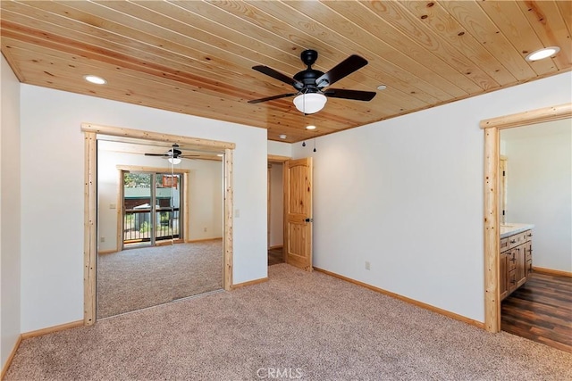 unfurnished bedroom featuring light carpet, ceiling fan, and wooden ceiling