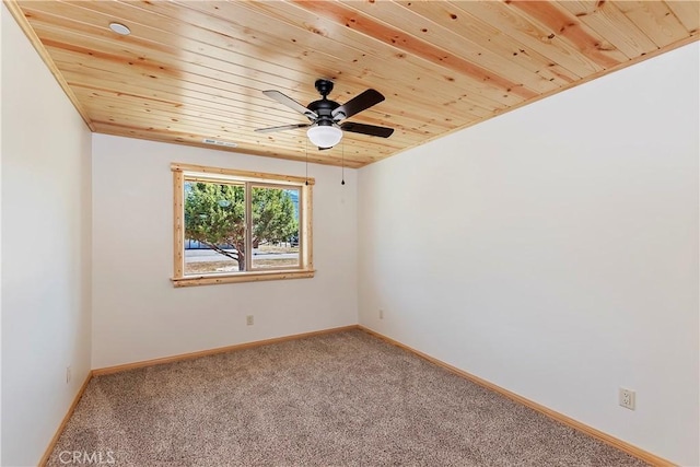 carpeted empty room featuring ceiling fan and wooden ceiling