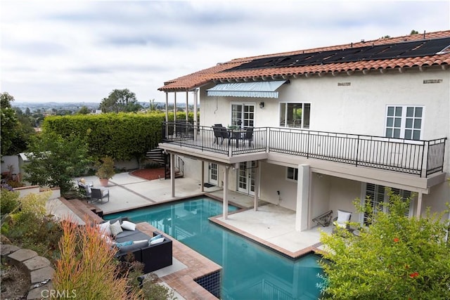 6829 Corintia St, Carlsbad, CA 92009 - back of property with a patio area, stucco siding, french doors, and roof mounted solar panels