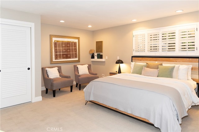 bedroom featuring light carpet and a closet