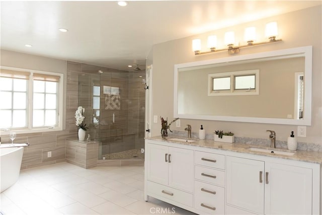 6829 Corintia St, Carlsbad, CA 92009 - full bath featuring tile patterned flooring, a stall shower, double vanity, a freestanding bath, and recessed lighting