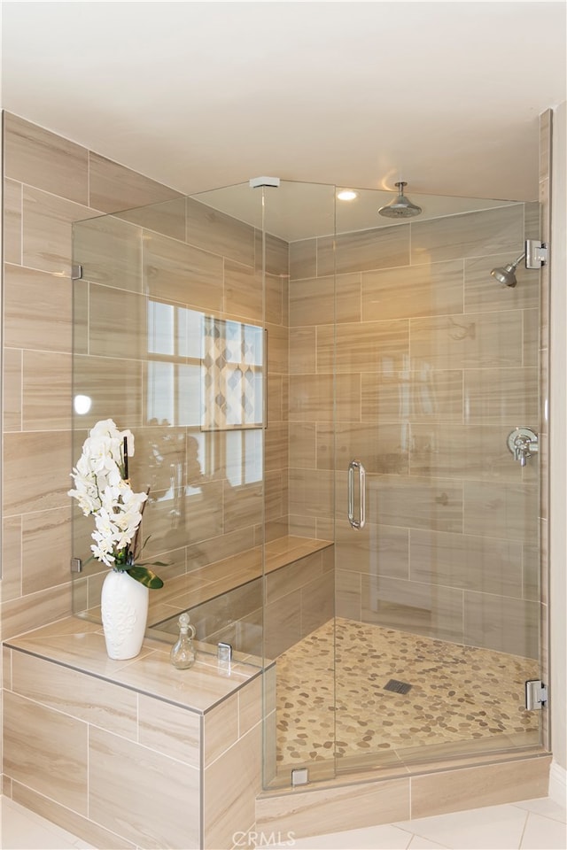 bathroom with tile patterned flooring and a shower with door