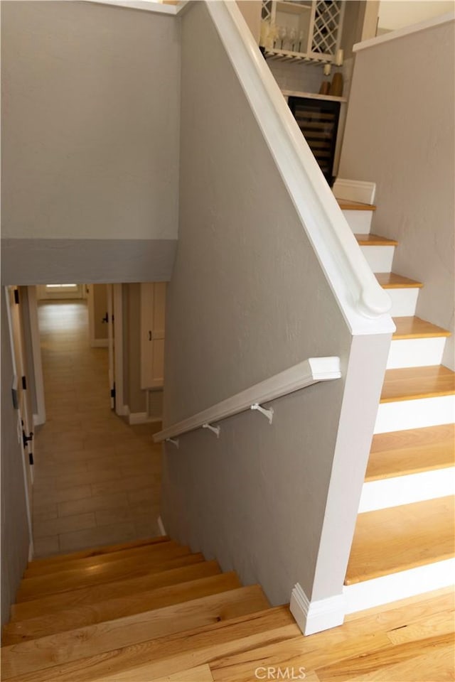 stairway with hardwood / wood-style floors