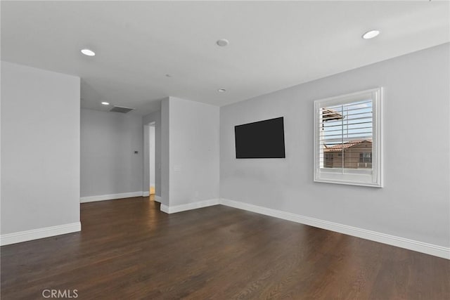 empty room with dark hardwood / wood-style floors