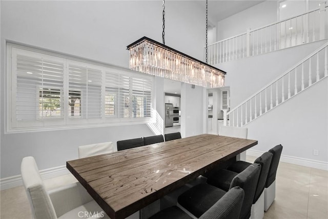 tiled dining space with an inviting chandelier