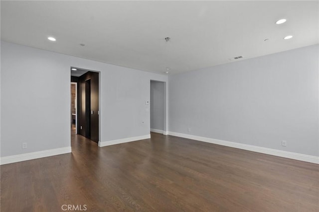 spare room with dark hardwood / wood-style floors