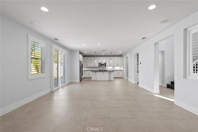 unfurnished living room with light tile patterned floors