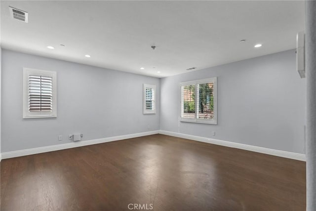 unfurnished room with dark hardwood / wood-style flooring