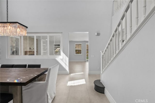 dining room with light tile patterned flooring and an inviting chandelier