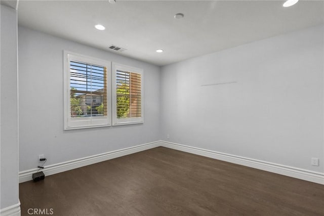 spare room with dark hardwood / wood-style flooring