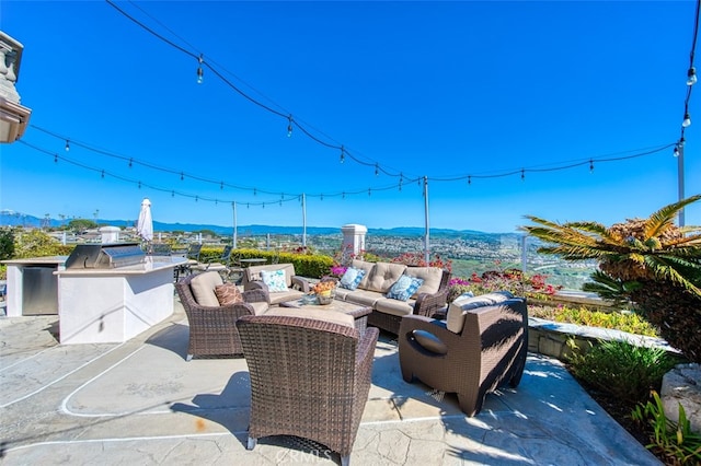 view of patio featuring a mountain view and an outdoor kitchen