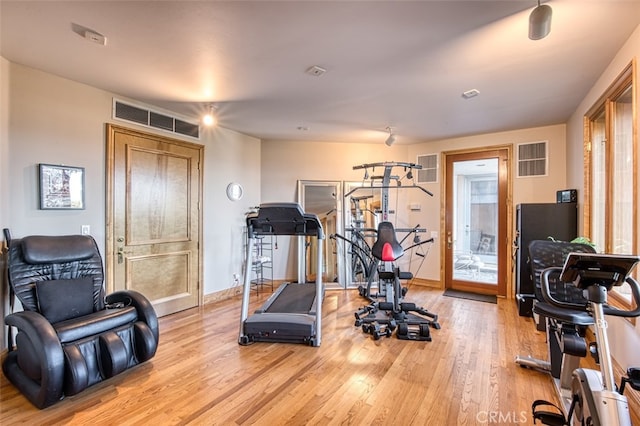 exercise room featuring light hardwood / wood-style floors