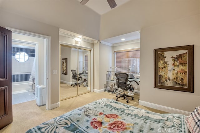 carpeted bedroom with crown molding, ceiling fan, and a closet