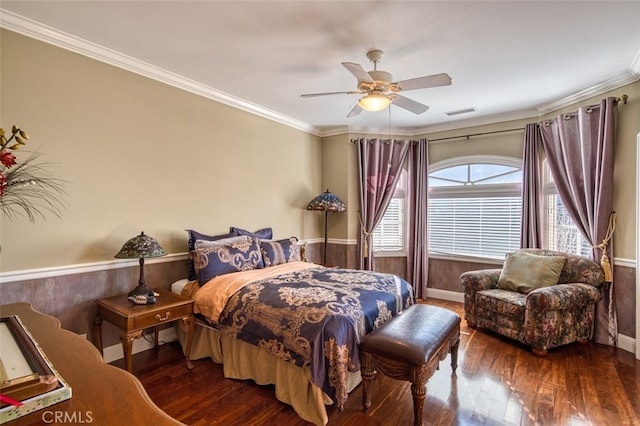 bedroom featuring crown molding, dark wood-type flooring, and ceiling fan