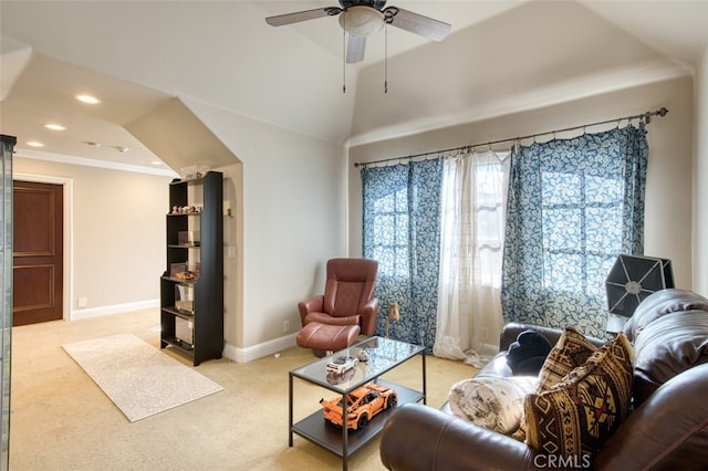 carpeted living room with ceiling fan and ornamental molding