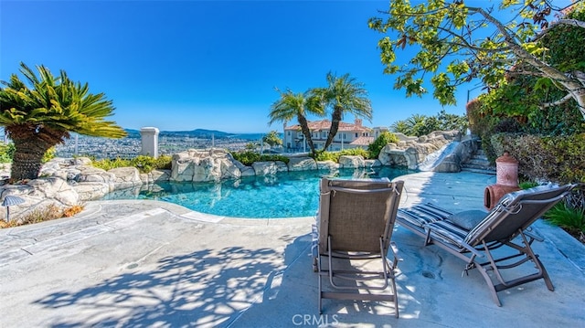 view of pool with a mountain view and a patio area