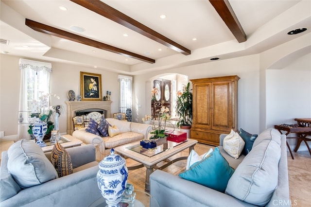 living room featuring a wealth of natural light and beamed ceiling