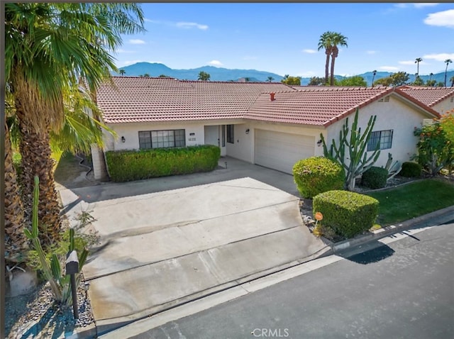 view of front of house with a mountain view and a garage