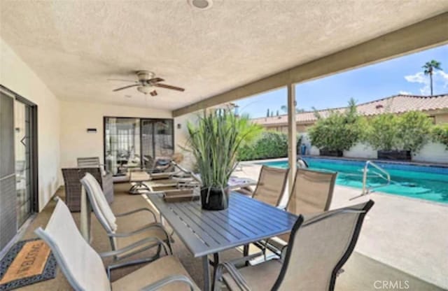 view of patio featuring a fenced in pool and ceiling fan