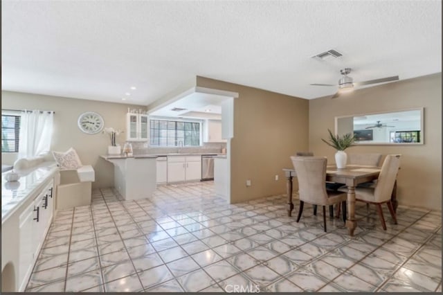 dining room with a textured ceiling and ceiling fan