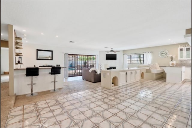 unfurnished living room with ceiling fan