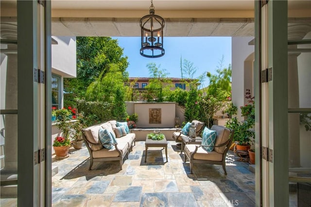 view of patio / terrace featuring french doors and an outdoor living space