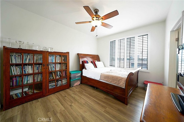 bedroom featuring hardwood / wood-style floors and ceiling fan