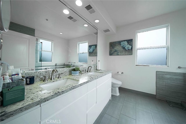 bathroom with toilet and vanity