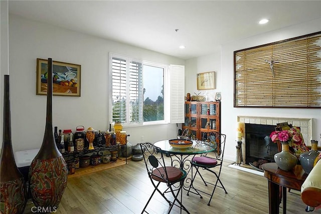 4568 W 1st St Unit 307, Los Angeles, CA 90004 - dining space featuring recessed lighting, a glass covered fireplace, and wood finished floors