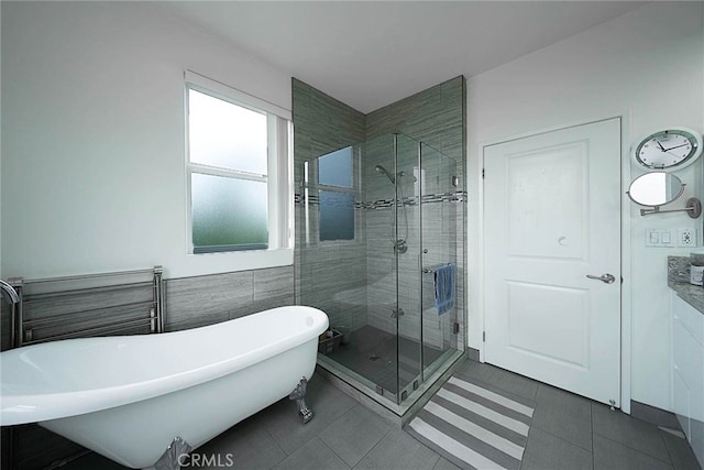 bathroom featuring tile walls, tile patterned floors, and separate shower and tub