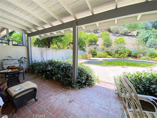 view of patio / terrace with a pool with hot tub