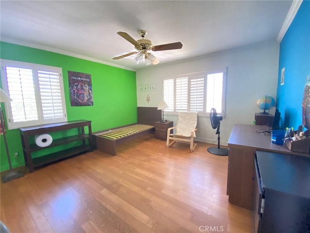 interior space with crown molding, light hardwood / wood-style flooring, and ceiling fan