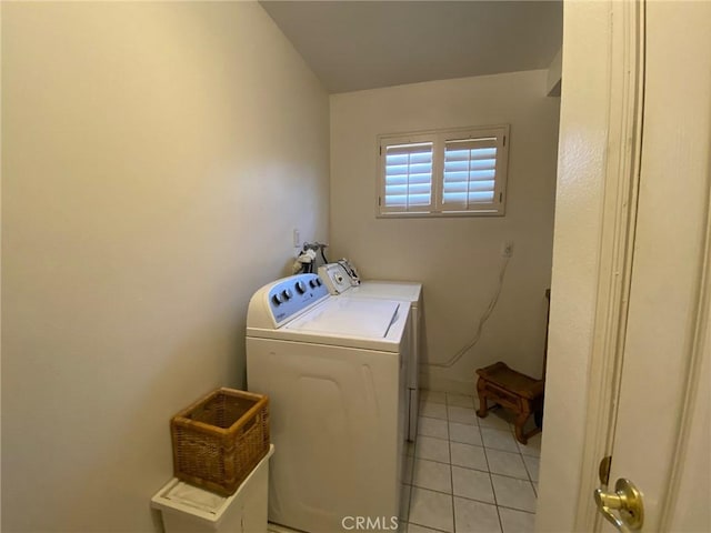 laundry area with light tile patterned floors and washing machine and clothes dryer