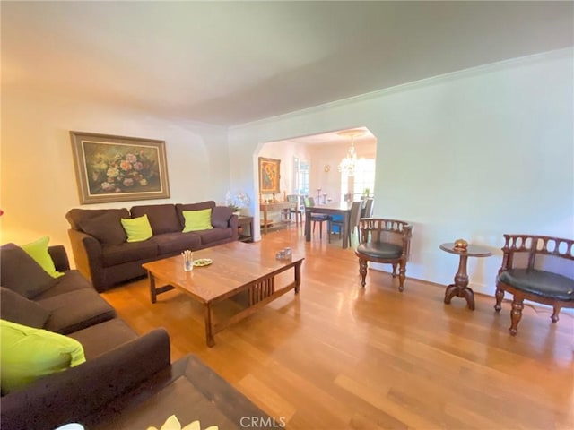 living room with wood-type flooring and an inviting chandelier