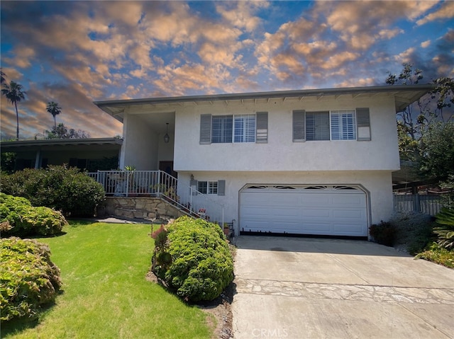 view of front of home with a yard and a garage