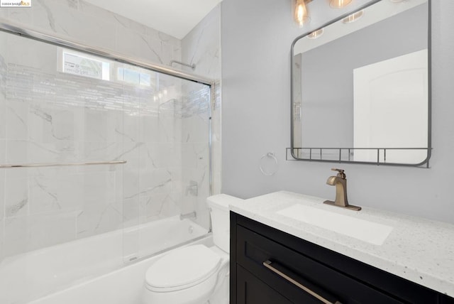 full bathroom with shower / bath combination with glass door, vanity, and toilet