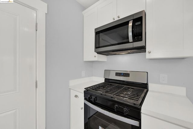 kitchen with stainless steel appliances and white cabinets