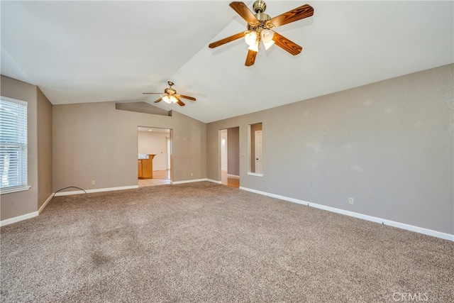 carpeted spare room featuring ceiling fan and lofted ceiling