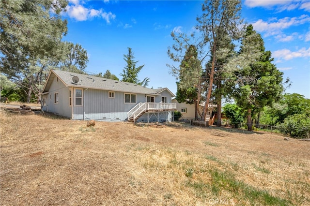 rear view of property with a wooden deck